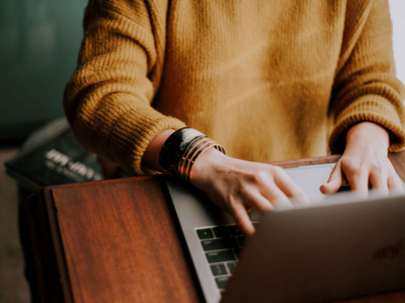 A woman typing in her laptop